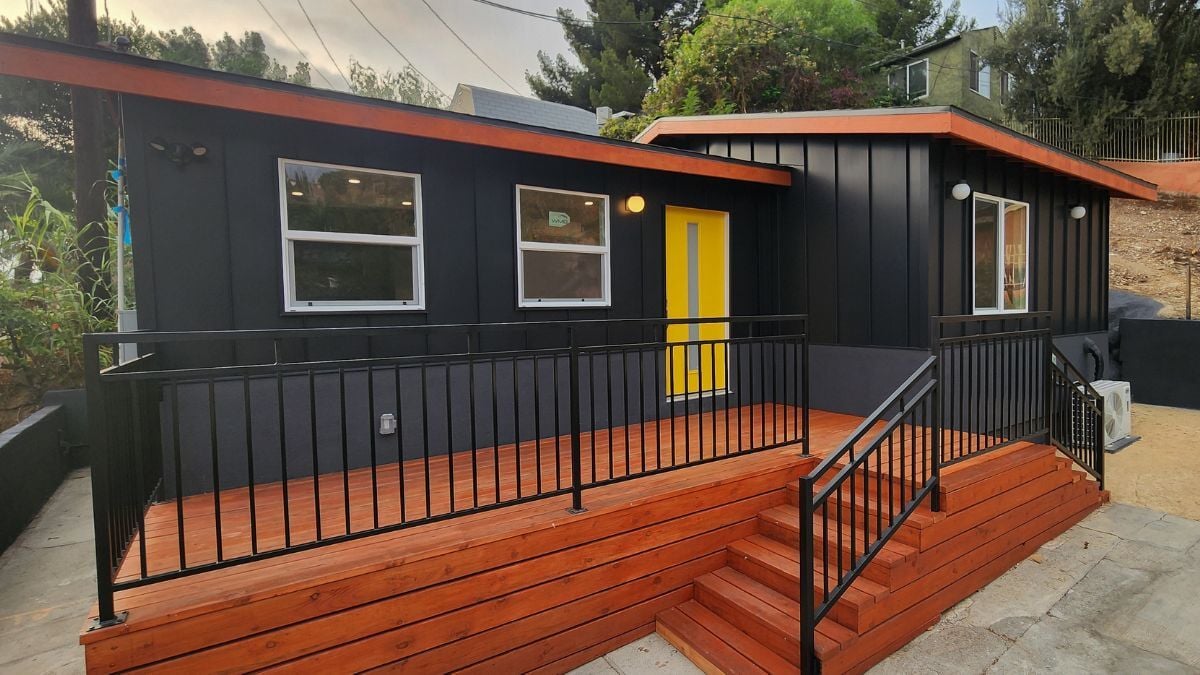 Modern black bungalow remodel with wood deck