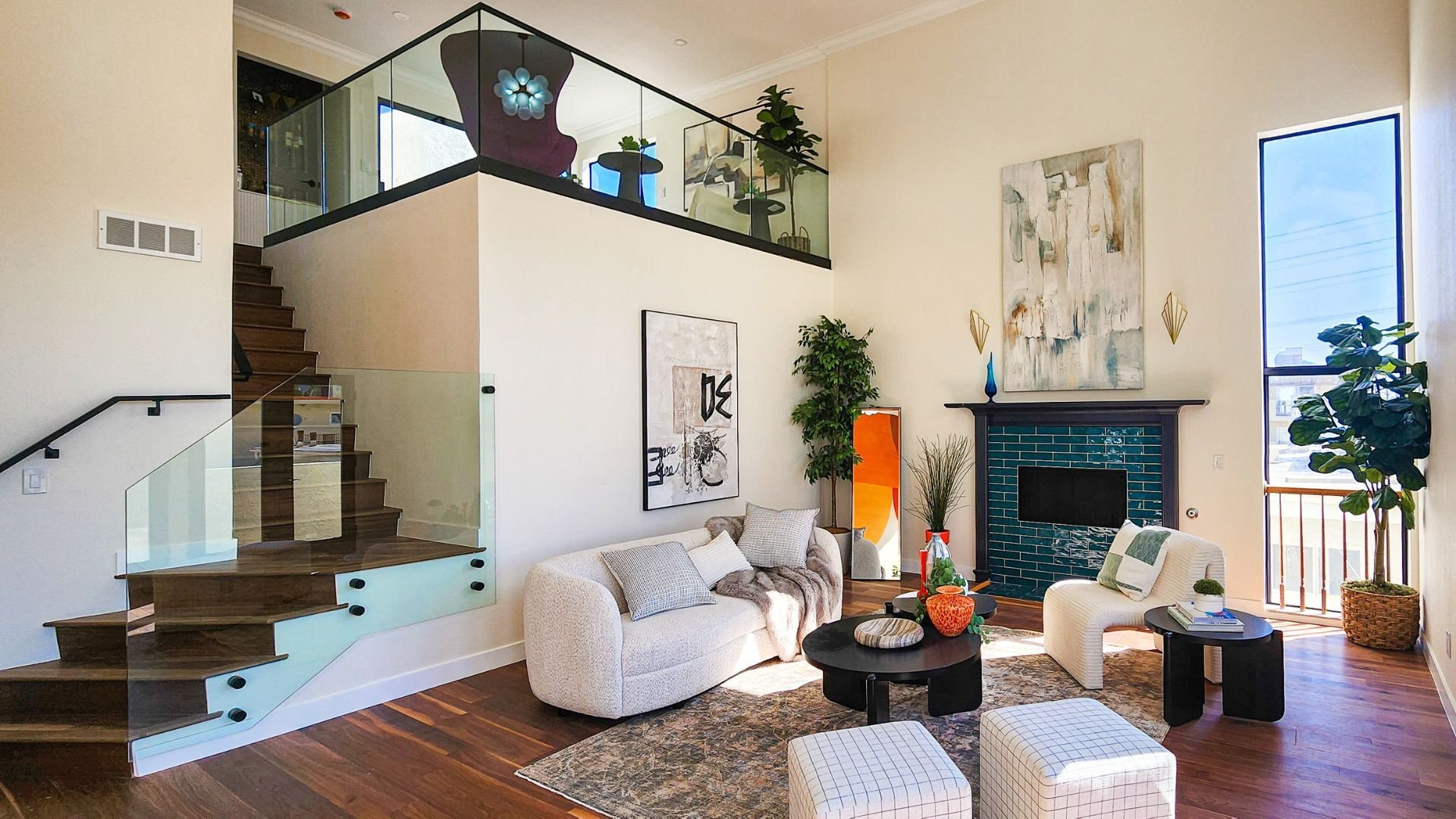 Modern residential living room with custom wood staircase and contemporary fireplace